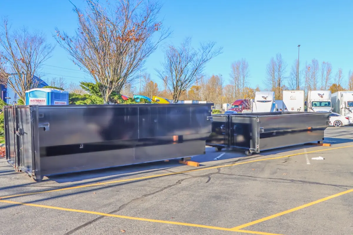 Professional dumpster rental service with roll-off container on residential driveway in Sterling